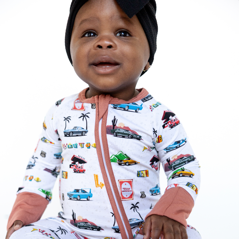 Baby wearing American Road Trip bamboo pajamas featuring american muscle cars  - Gearhead Kids