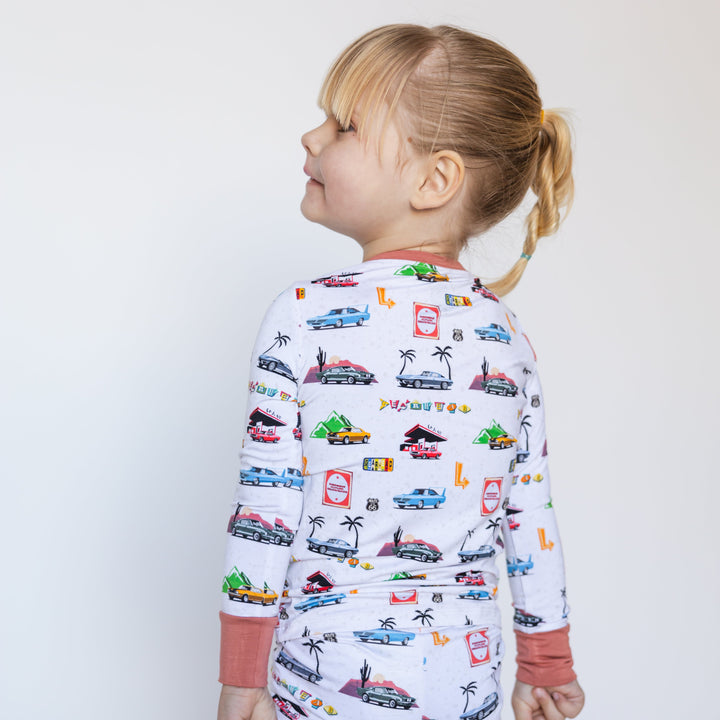 Girl wearing American muscle car pajamas featuring vintage Mustang Fastback, Corvette C2 and Camaro Z28- Gearhead Kids