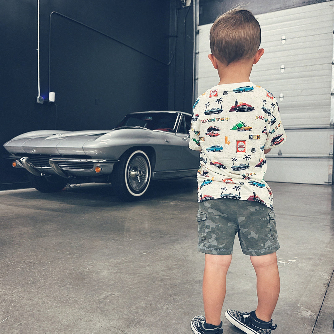 Toddler boy wearing American muscle car t-shirt while looking vintage car - Gearhead Kids