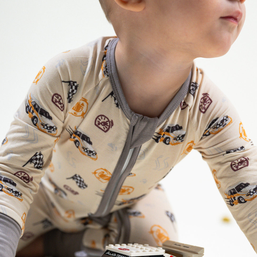 Close-up baby wearing 2-way reversible zipper on Audi Quattro S1 bamboo  pajamas for easy diaper changes - Gearhead Kids