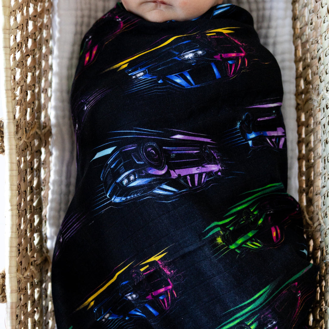 Newborn baby wrapped up in JDM car print bamboo swaddle blanket - Gearhead Kids