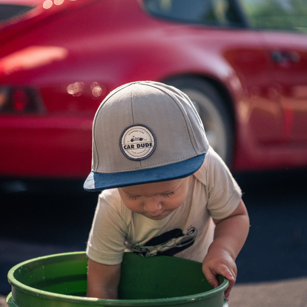 Child wearing the premium CAR DUDE suede-brim hat while washing cars - Gearhead Kids