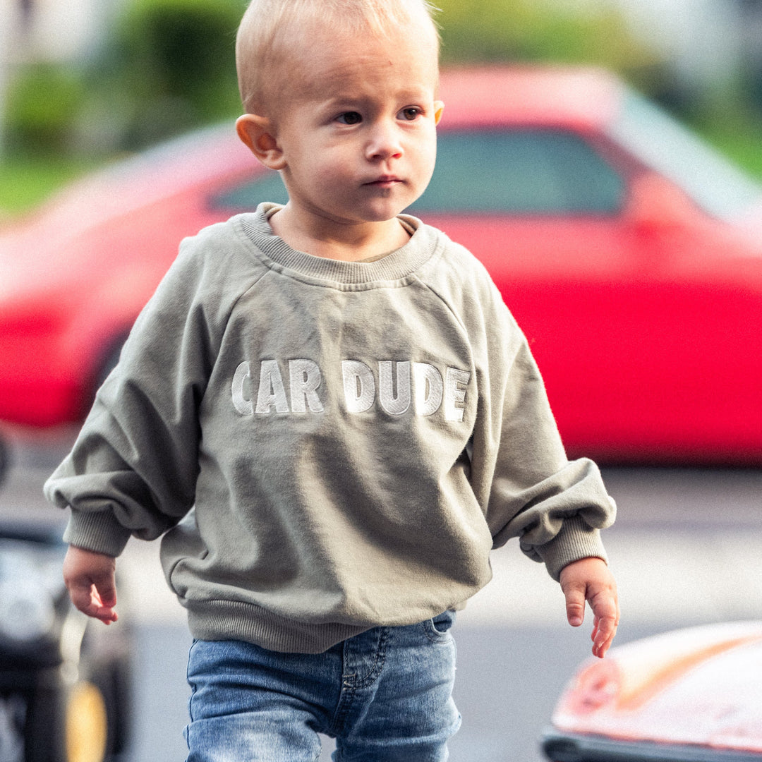 Toddler wearing a sage green sweatshirt with embroidered CAR DUDE - Gearhead Kids