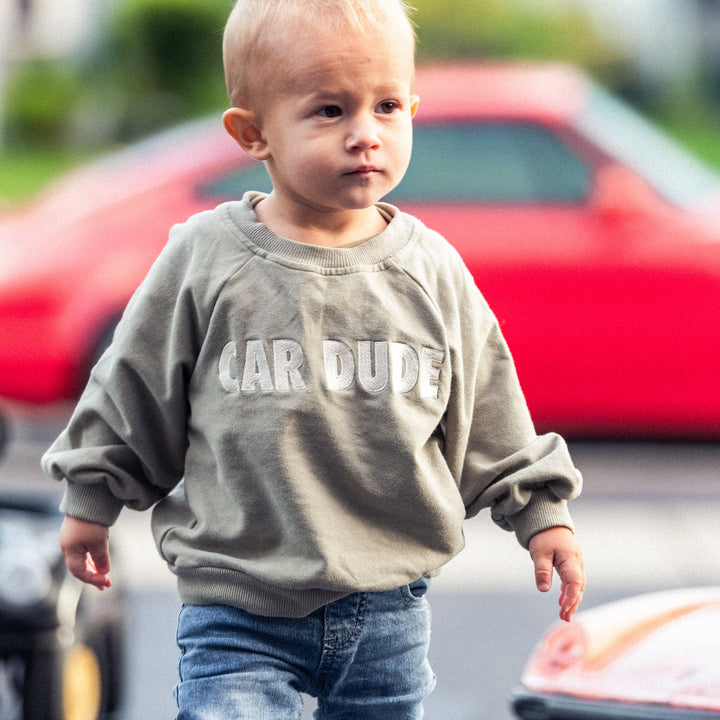 Toddler wearing a sage green sweatshirt with embroidered CAR DUDE - Gearhead Kids