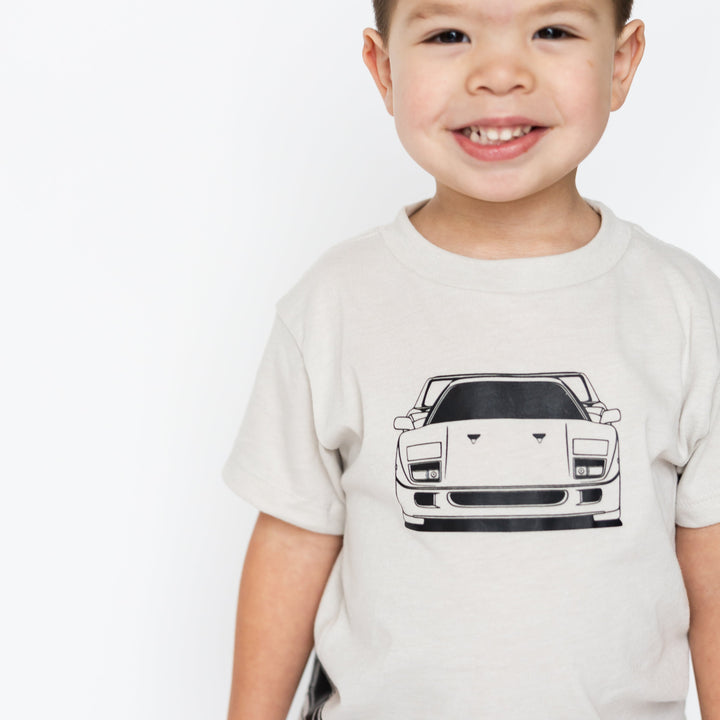Toddler wearing a minimalist Ferrari F40 blueprint style t-shirt for kids in dust - Gearhead Kids