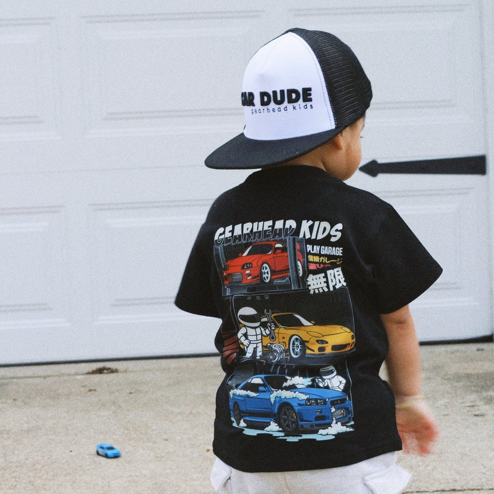 Toddler Kid wearing a Gearhead Kids - Play Garage t-shirt featuring Japanese Legend Cars - Nissan R34, Toyota Supra, and Mazda RX-7.  Car Apprel for Kids.