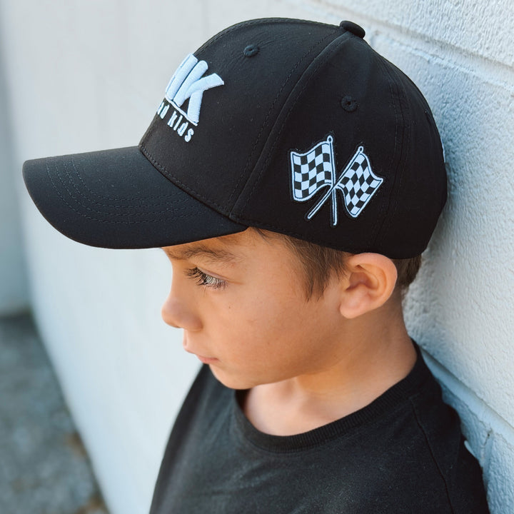 Little boy wearing a Gearhead Kids No Limits hat - side view featuring checkered racing flags
