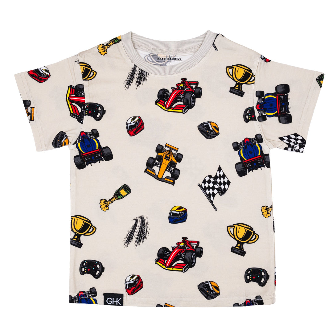 Grand Prix  t-shirt featuring an all-over repeating pattern of red, orange and blue race cars, popping champagne bottles, gold trophies, and driver helmets. | Gearhead Kids