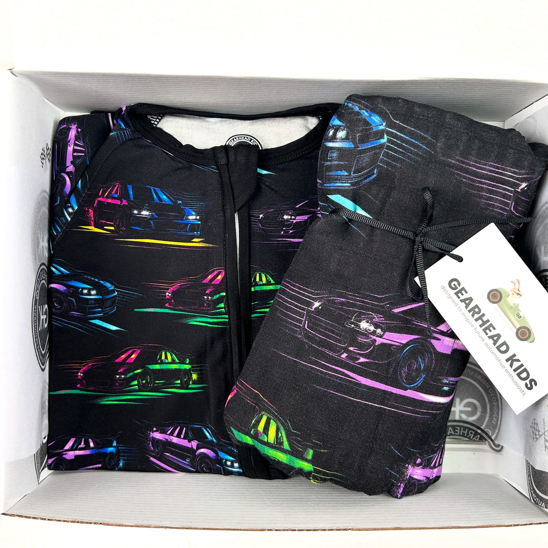 JDM Legends muslin swaddle featuring Skyline R34, Supra MK4, RX7, and WRX STI silhouettes in neon colors and a matching baby zipper pajama gift set for baby - gearhead kids