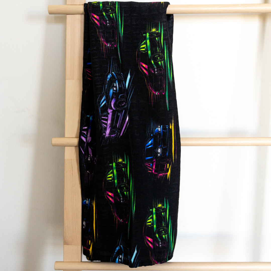 JDM Legends muslin swaddle featuring Skyline R34, Supra MK4, RX7, and WRX STI silhouettes  in neon colors - Gearhead Kids