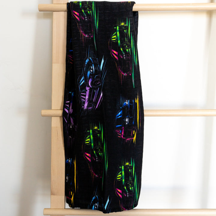 JDM Legends muslin swaddle featuring Skyline R34, Supra MK4, RX7, and WRX STI silhouettes  in neon colors - Gearhead Kids