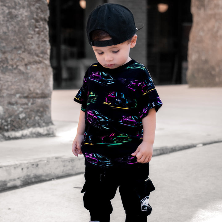 Toddler wearing JDM car t-shirt with silhouettes of Toyota Supra and Mazda RX7 - Gearhead Kids