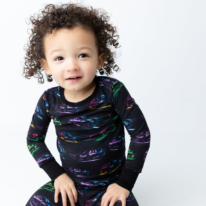 Toddler wearing JDM Legends bamboo pajamas featuring Nissan R34 GTR and Toyota Supra MK4 silhouettes - Gearhead Kids