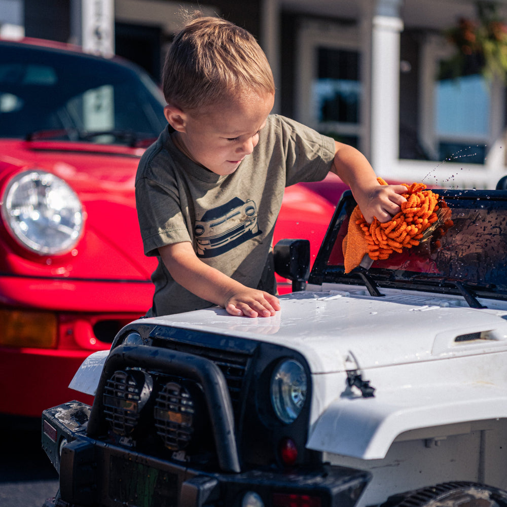 Toddler  wearing a Lamborghini Miura t-shirt while washing his car outside - Gearhead Kids