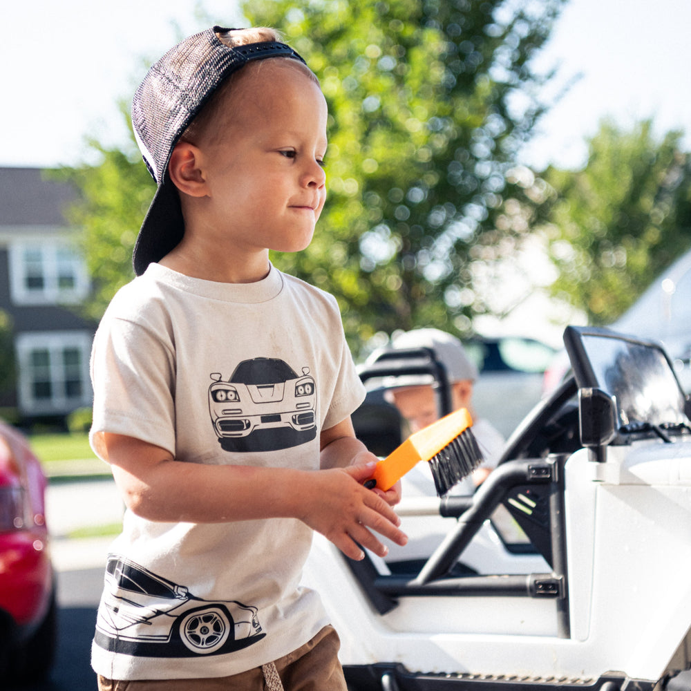 Young car enthusiast wearing a McLaren F1 triple-profile graphic tee in dust - Gearhead Kids