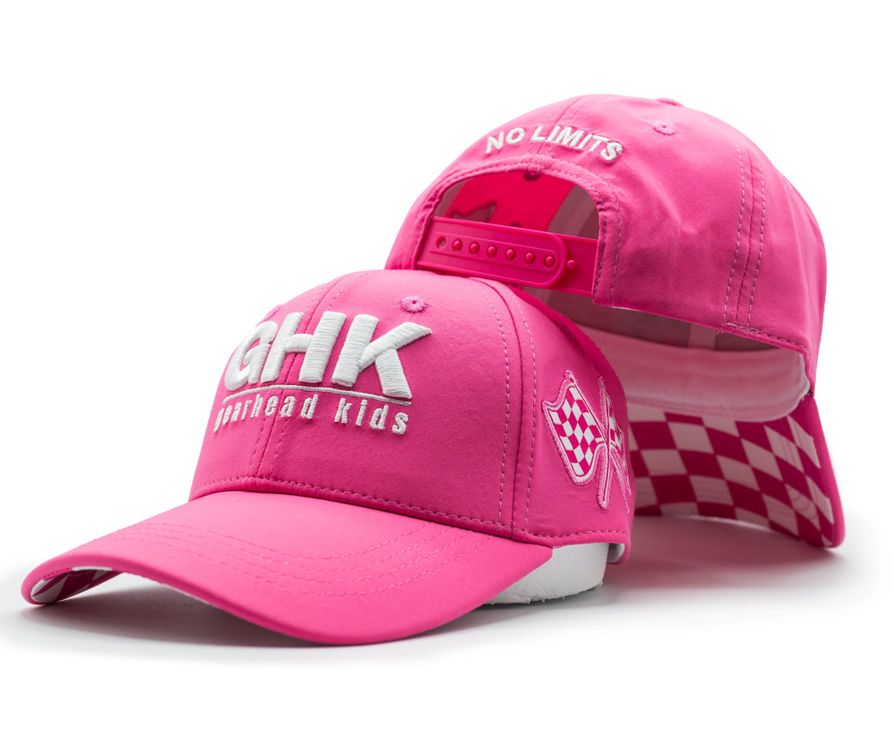 A bright pink snapback hat shown from the front and back. The front features white embroidered text reading 'GHK' and 'gearhead kids', while the back displays 'NO LIMITS' in white. 