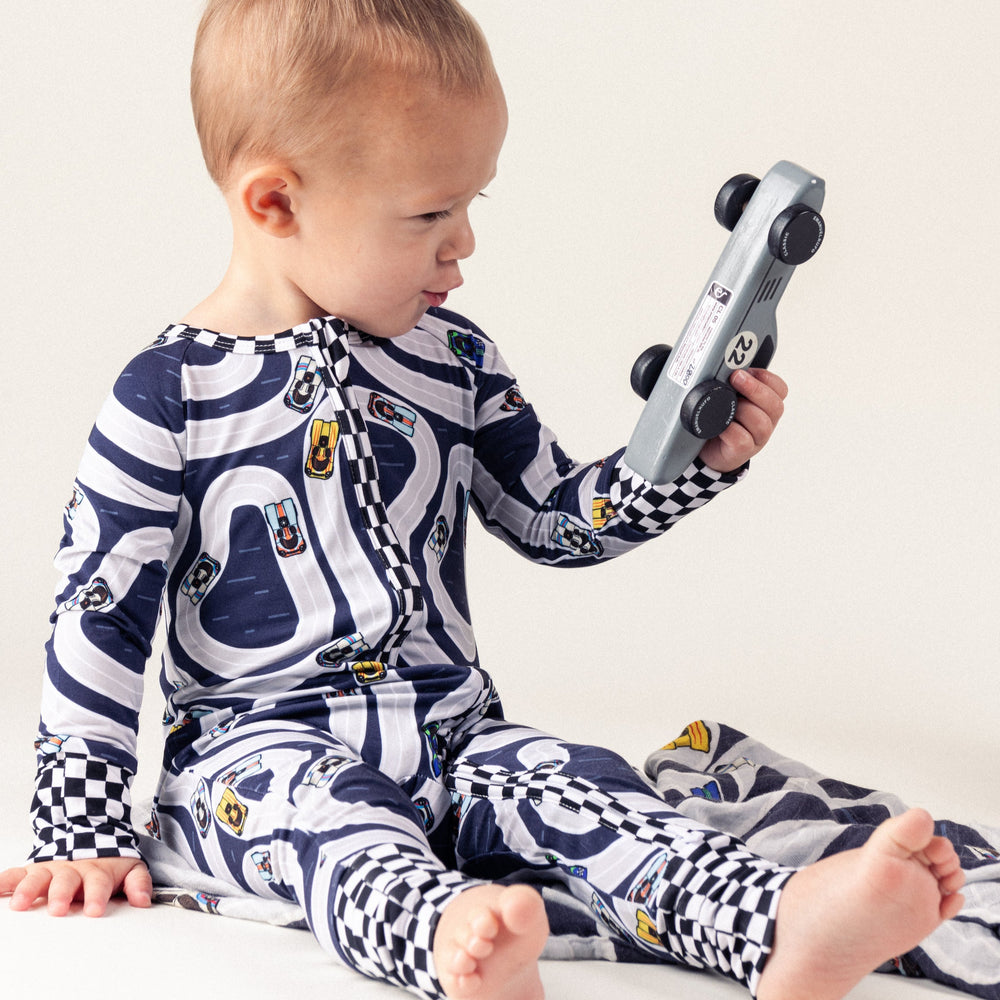Infant wearing 917 race car zipper pajamas  playing with car - Gearhead Kids