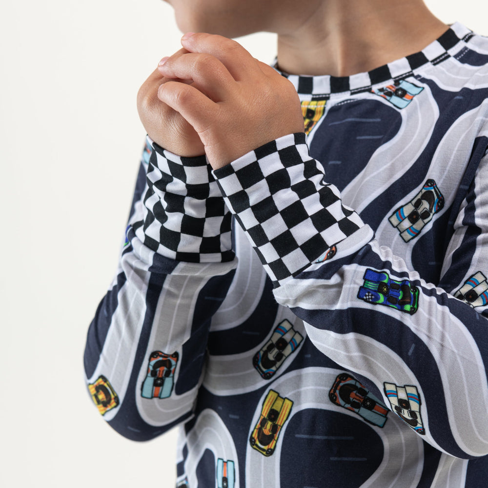 Close-up of vintage Porsche 917 race car print on soft bamboo pajama fabric with racing checkerflag details -  Gearhead Kids