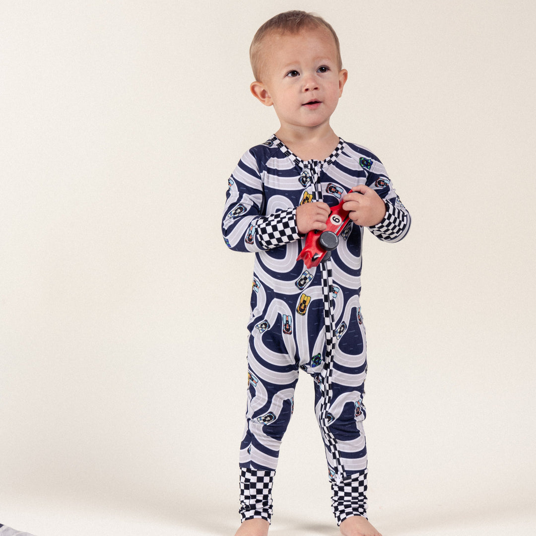 Infant wearing Porsche 917 on track pajamas featuring Gulf livery, Martini Livery, Hippie Livery - Gearhead Kids