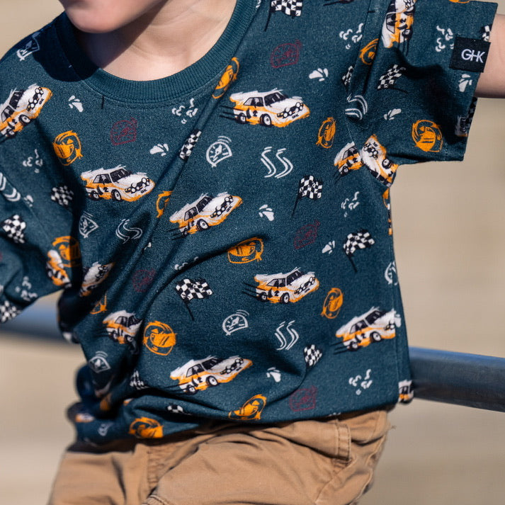 Young boy wearing an oversized Audi Quattro S1 inspired tee while playing outside- Gearhead Kids